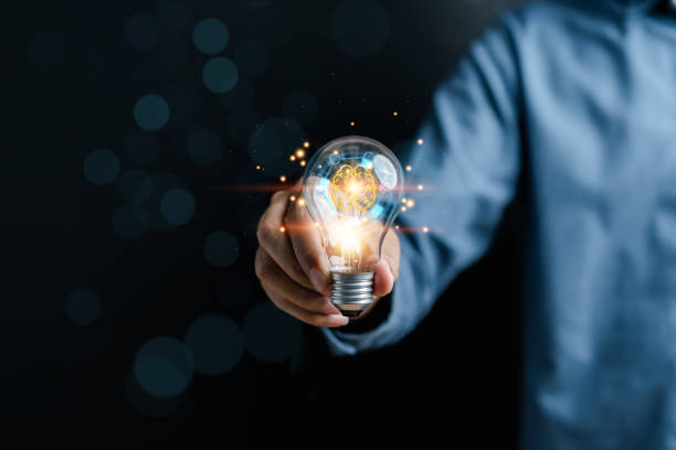 istock Hand man holding illuminated lightbulb, idea, innovation and inspiration with glowing virtual brain, smart intelligent creativity with bulbs, Motivation and innovation concept 1492025480