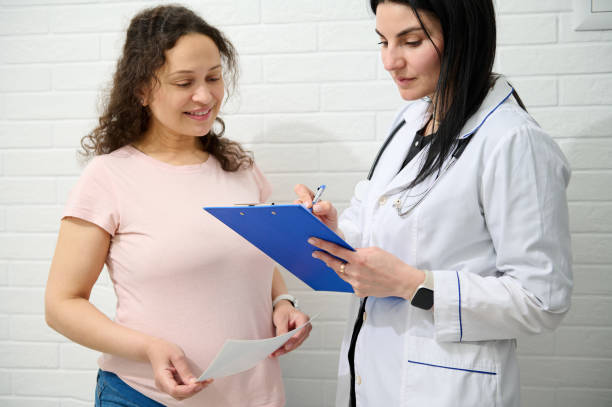 istock Multi ethnic pregnant woman at obstetrician appointment. 1492027177