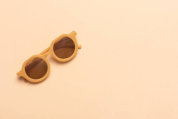 istock Brown children's glasses on a brown background 1492028048