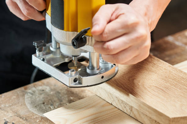 istock The hands of a Caucasian worker set up a position to start processing a wooden workpiece using an electric router 1492032788