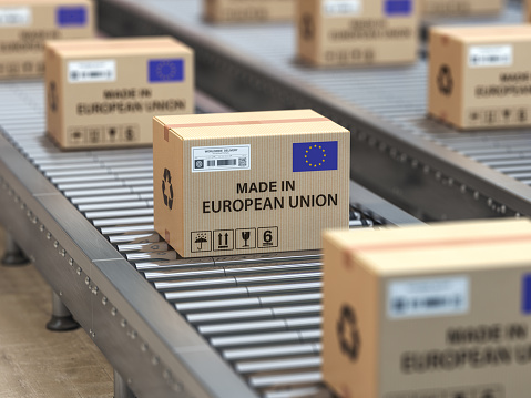 Made in European Union. Cardboard boxes with text made in European Union and EU flag on the roller conveyor. 3d illustration