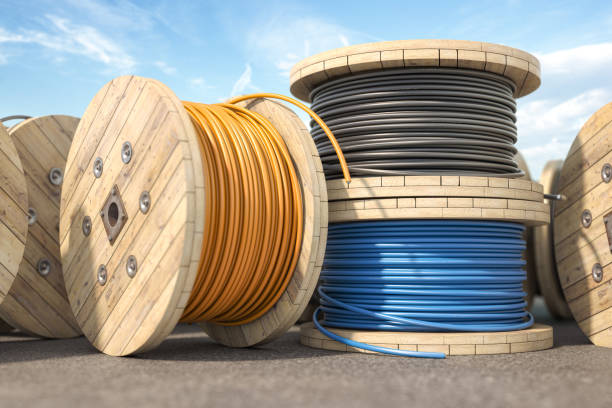 Wire electric cable of different colors on wooden coil or spool in warehouse. Wire electric cable of different colors on wooden coil or spool in warehouse. 3d illustration wooden spool stock pictures, royalty-free photos & images