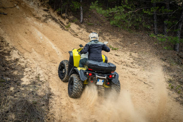 Professional quad biker rides fast on sand. Quad racing, ATV 4x4