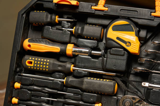 istock Screwdriver handle for interchangeable bits, Phillips and flat screwdrivers, tape measure in a set of locksmith tools 1492038159