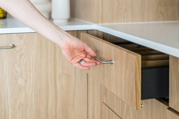 istock Female hand opening kitchen wooden storage with metal handle 1492039421