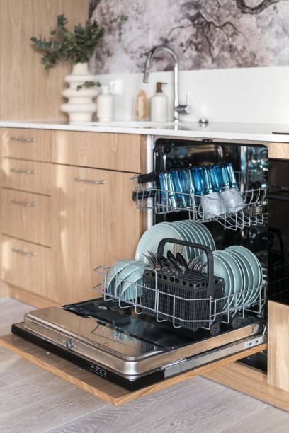 istock Opened full loaded dishwasher machine in contemporary kitchen 1492039422