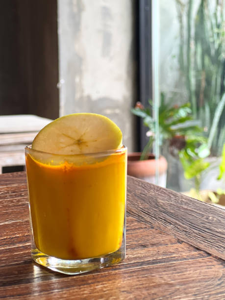 istock Vegan Pressed Turmeric Shot in Glass with Apple Slice Garnish 1492044729