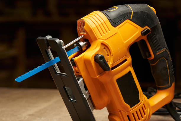 istock yellow-black electric jigsaw with blue saw blade, laser light, speed controller and support platform close-up 1492049986