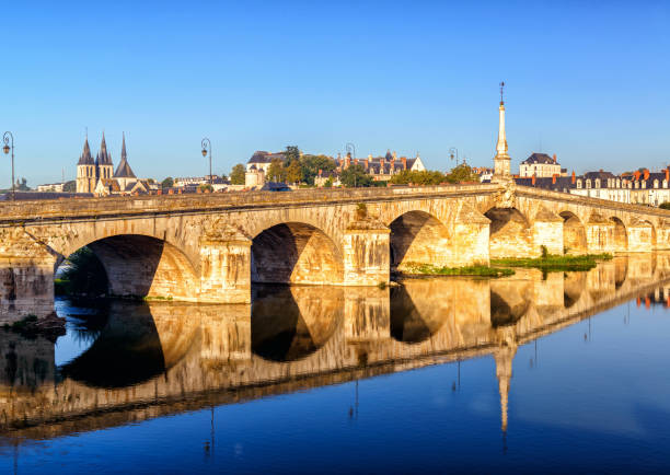 Old bridge in Blois, France, Europe. Scenery of vintage stone structure over Loire River Old bridge in Blois, France, Europe. Scenery of vintage stone structure over Loire River, historical landmark of Blois city. Theme of travel and summer vacation in Blois town. blois stock pictures, royalty-free photos & images