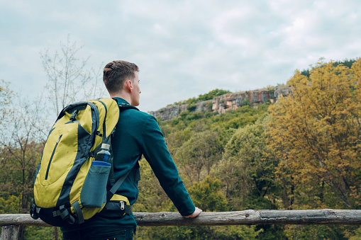 Young male backpacker enjoying the view in nature