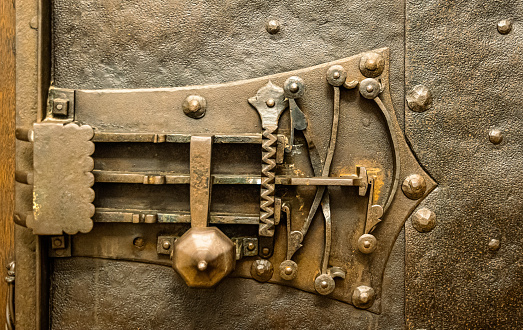 Ancient medieval lock mechanism in a safe case.