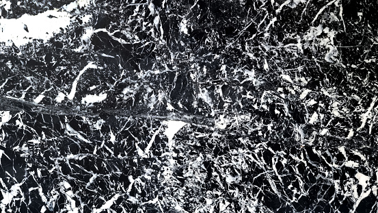 close up of a black marble background with high contrast of rustic mineral veins pattern. marble black and white vein background for interior finishing material such as floor, wall, counter.