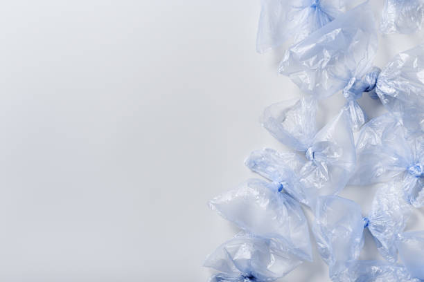 istock Colored used plastic bags flat lay, polyethylene packages on light background. Sustainable lifestyle, plastic free, eco trend to reduce disposable plastic, creative top view frame with copy space 1492060212