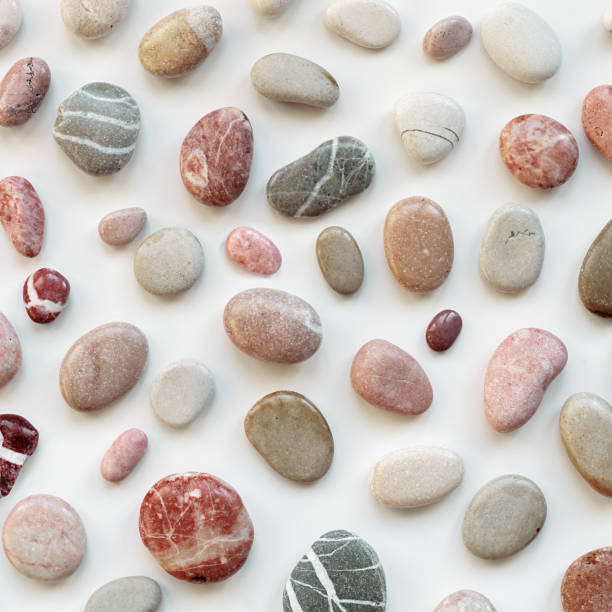 istock Background with natural colored sea stones. Smooth round pebbles as pattern on light background. Minimal summer card, still life with various grey, pink rocks, spa and relaxation concept 1492060354