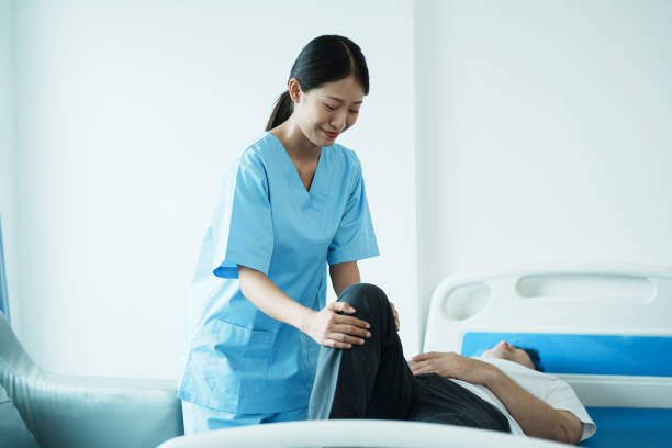 istock Therapist doing leg stretching exercises with senior patient in the clinic. 1492062331