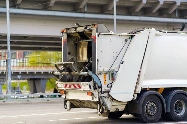 istock A white car for collecting and transporting garbage is driving along the highway 1492066187