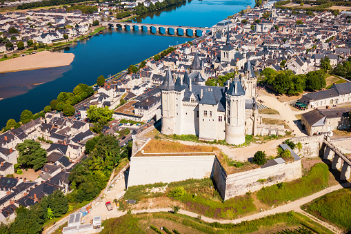 Chambord, France -May 26, 2014 - The roof top and various chimneys of  Chambord Palace. Built as a hunting lodge for King Francois I, between 1519 and 1539. For scale, note the size of visitors along the roofline.