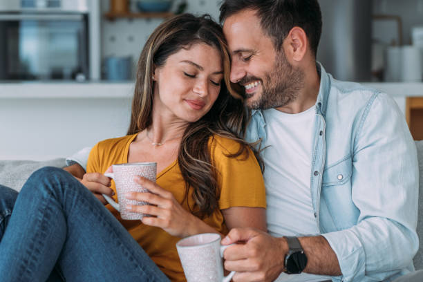 istock Lovely young couple drinking coffee at home. 1492068053