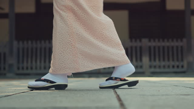 Closeup - shoe of asian woman wearing japanese traditional kimono dress walking in old town, Kimono girl enjoy outdoor lifestyle activity travel in the city of Japan.