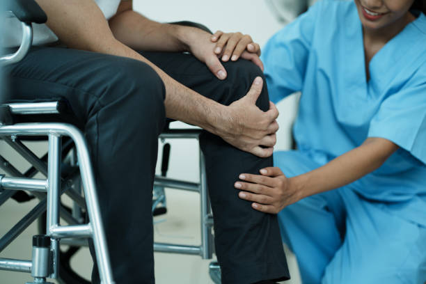 istock Orthopedic doctor checkup knee bone disability wheel chair patient. 1492073497