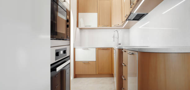 istock Modern wooden home kitchen with appliances, wide view with copy space 1492073806