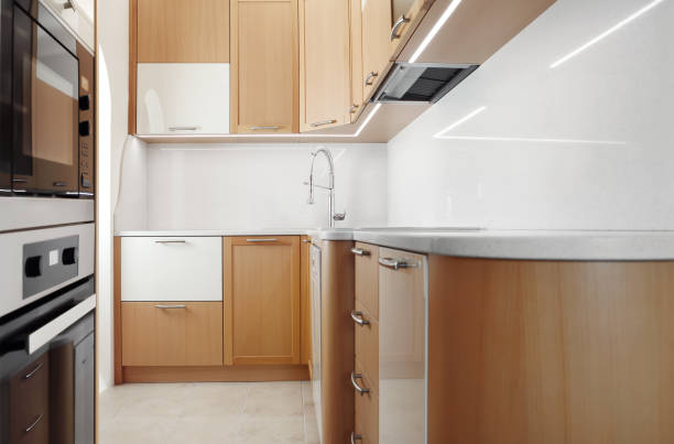 istock Modern wooden home kitchen with appliances, wide view with copy space 1492074890