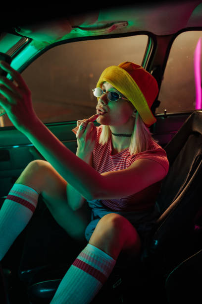 istock Retro girl doing makeup in car. 1492076642