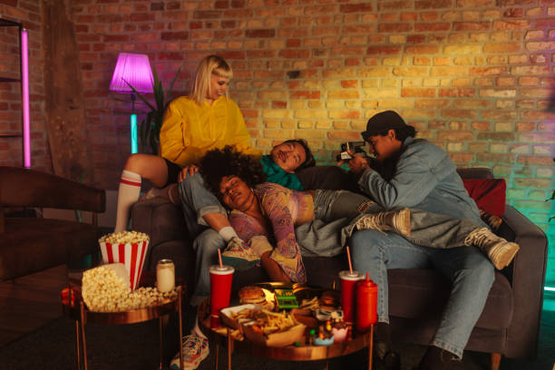 istock Man takes polaroid of sleeping friends. 1492076675