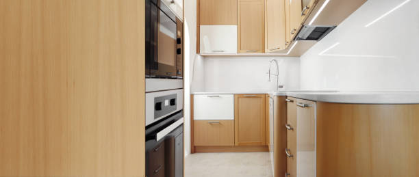 istock Modern wooden home kitchen with appliances, wide view with copy space 1492077385