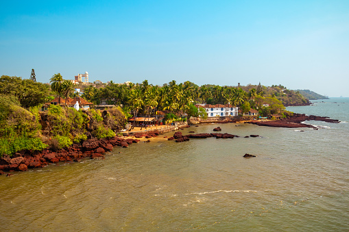 Lungi, Port Loko District, Sierra Leone: looking south along Lungi beach towards Freetown, vast extensions of coconut tree lined golden sand on the north side of the Sierra Leone river estuary