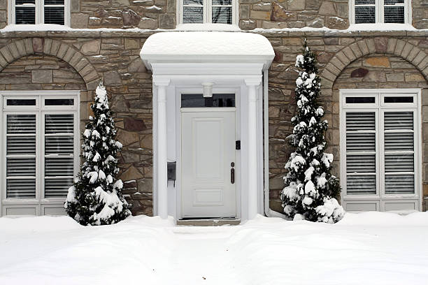 Snowy house with white door stock photo
