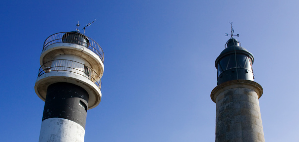 Ancient lighthouses close-up low angle view , clear blue sky background  in San Cibrao, Cervo, A Mariña, Lugo province, Galicia, Spain.