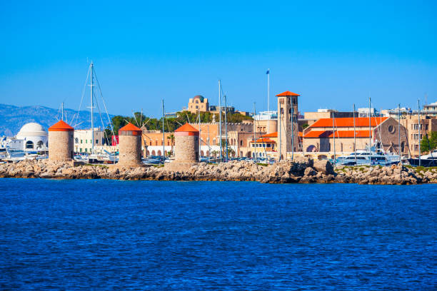 Windmills at the seafront in the city of Rhodes in Rhodes island in Greece