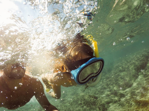 istock Family snorkel underwater in deep blue sea 1492086371