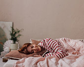 Beautiful Ginger Woman Lying in her Bed,  Sleeping in on a Weekend