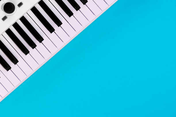 istock Piano keys on a blue background, top view, flat lay, copy space. 1492088247