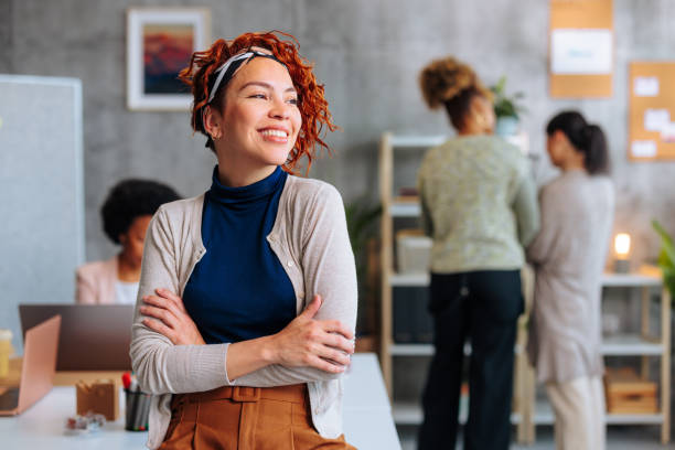 istock Attractive young Hispanic business woman looking on side while sitting in office. 1492089624