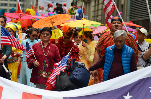 Chinese participants marche down Sixth Avenue during the Asian American and Pacific Islander Cultural and Heritage Parade in New York City, on May 21, 2023.