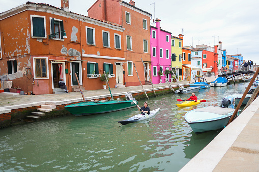 Burano island , Italy, Europe - 17.05.2023: Canoe rowing competitions in canal Burano island