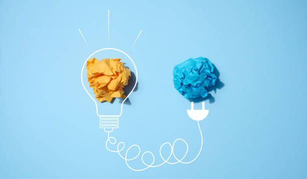 istock The concept of inspiration with new ideas, the search for creative solutions, crumpled sheets of paper in the form of balls on a blue background 1492096947
