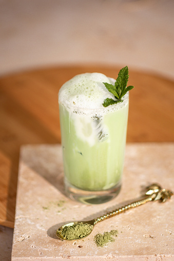 Iced Matcha Latte Drink with milk foam and green matcha powder