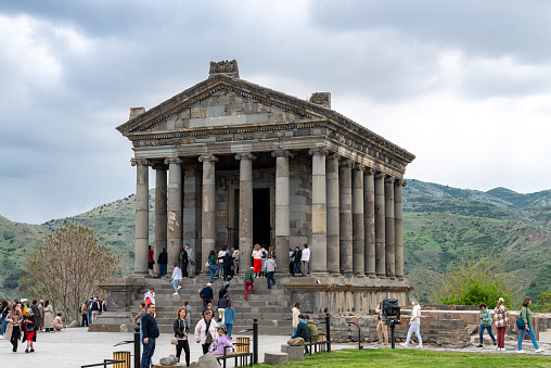 People visiting the greco-roman Temple of Garni located at central Armenia country.