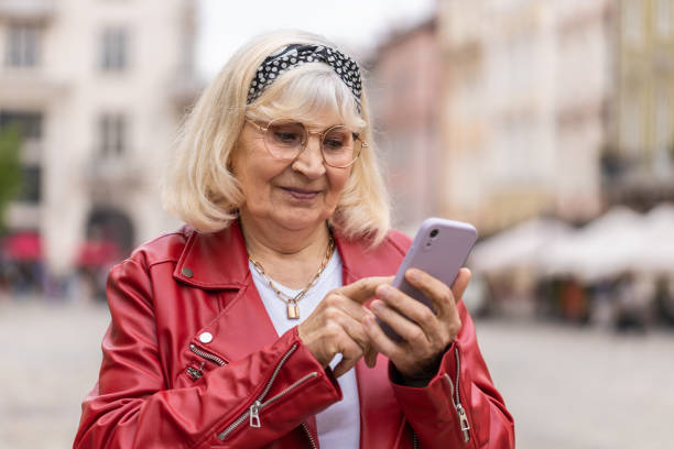 istock Senior woman using smartphone typing text messages looking for a way on map in mobile navigator app 1492100334