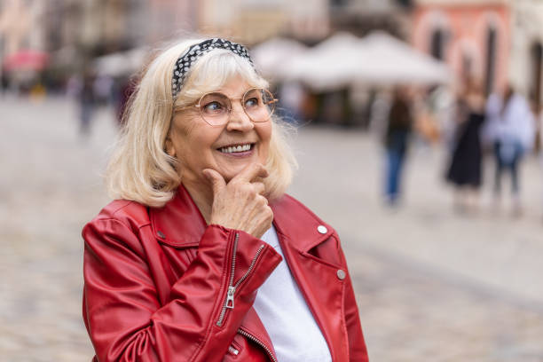 istock Thoughtful senior woman with pensive expression, pondering a solution thinking inspiration dreaming 1492100363