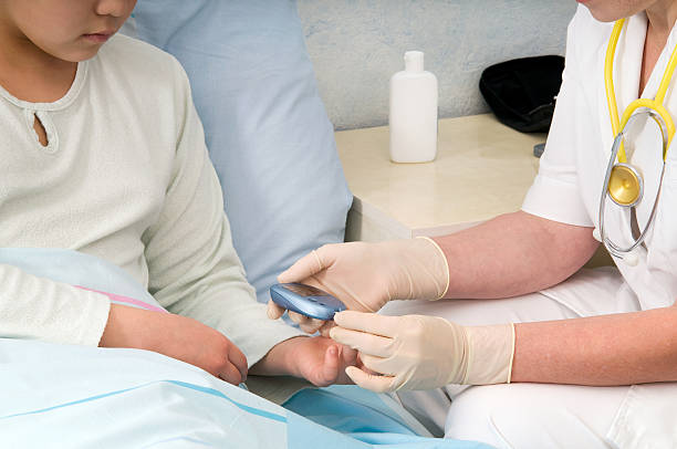A gloved person giving a patient a blood sugar test