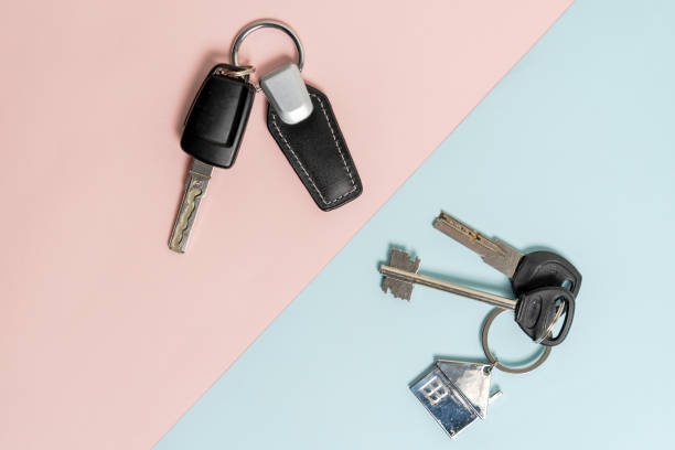 istock Keys from car and house on two colored background 1492102872