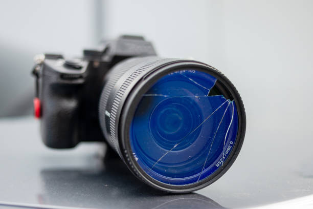 istock DSLR camera with broken protective glass for lens. Cracked photo-filter 1492102883