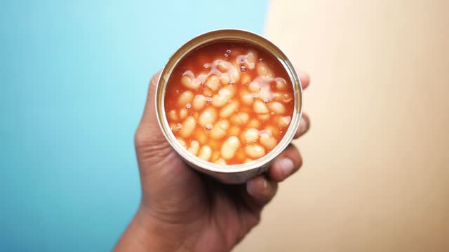 preserved canned tomato beans pouring into a bowl