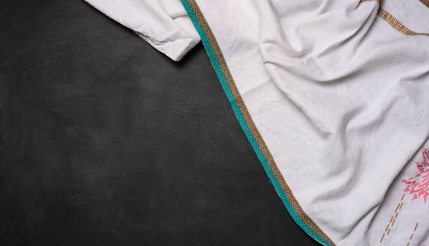 istock Folded  linen kitchen towel on a black background, top view. Copy space 1492106803