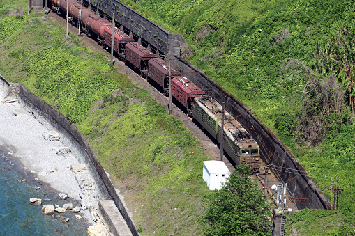 freight train moves along the seashore